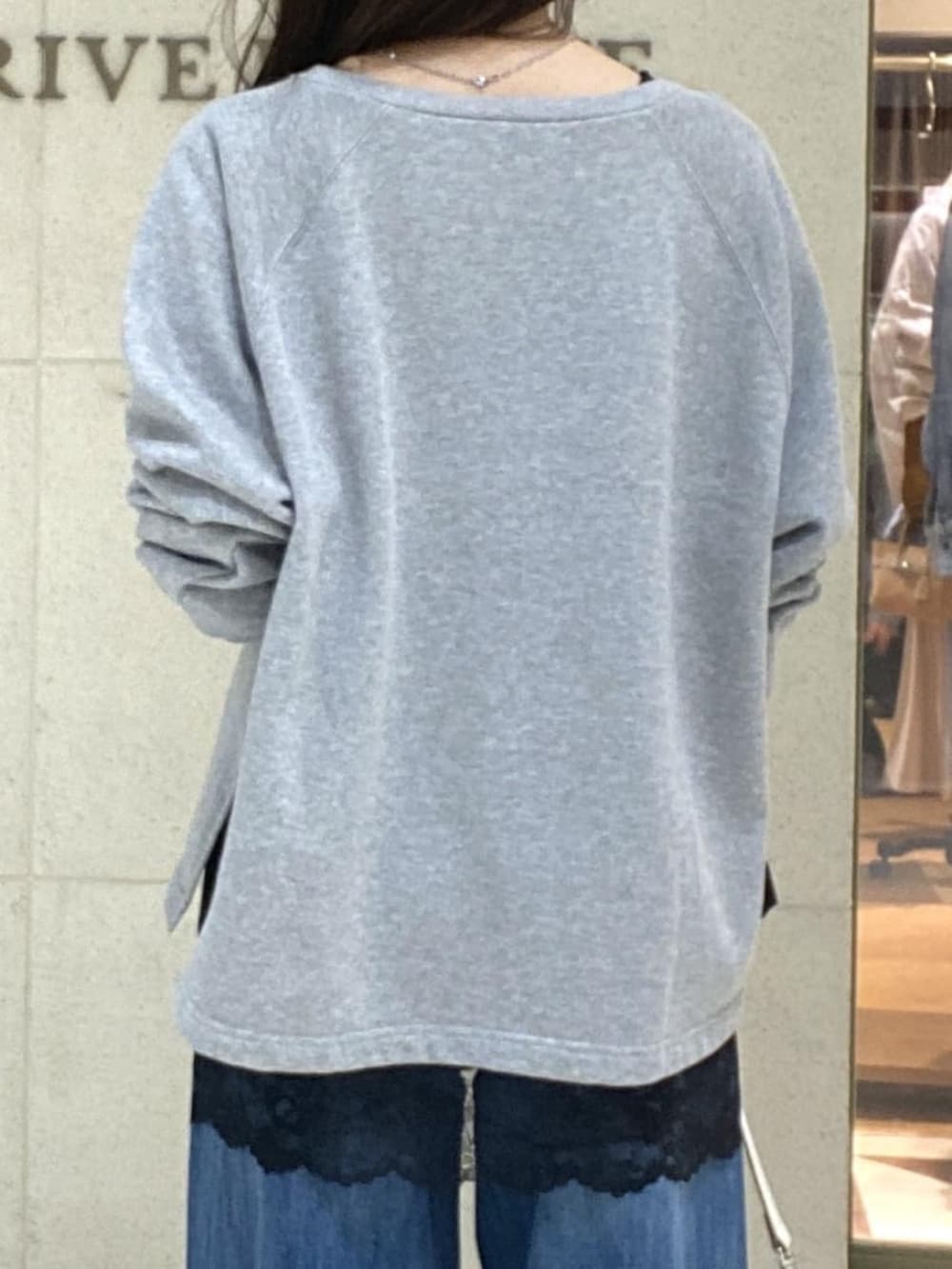 グレー系のスウェット、ブラウン系のキャミソール、ホワイト系のショルダーバッグを着用したレディースの春コーディネートの6枚目の写真