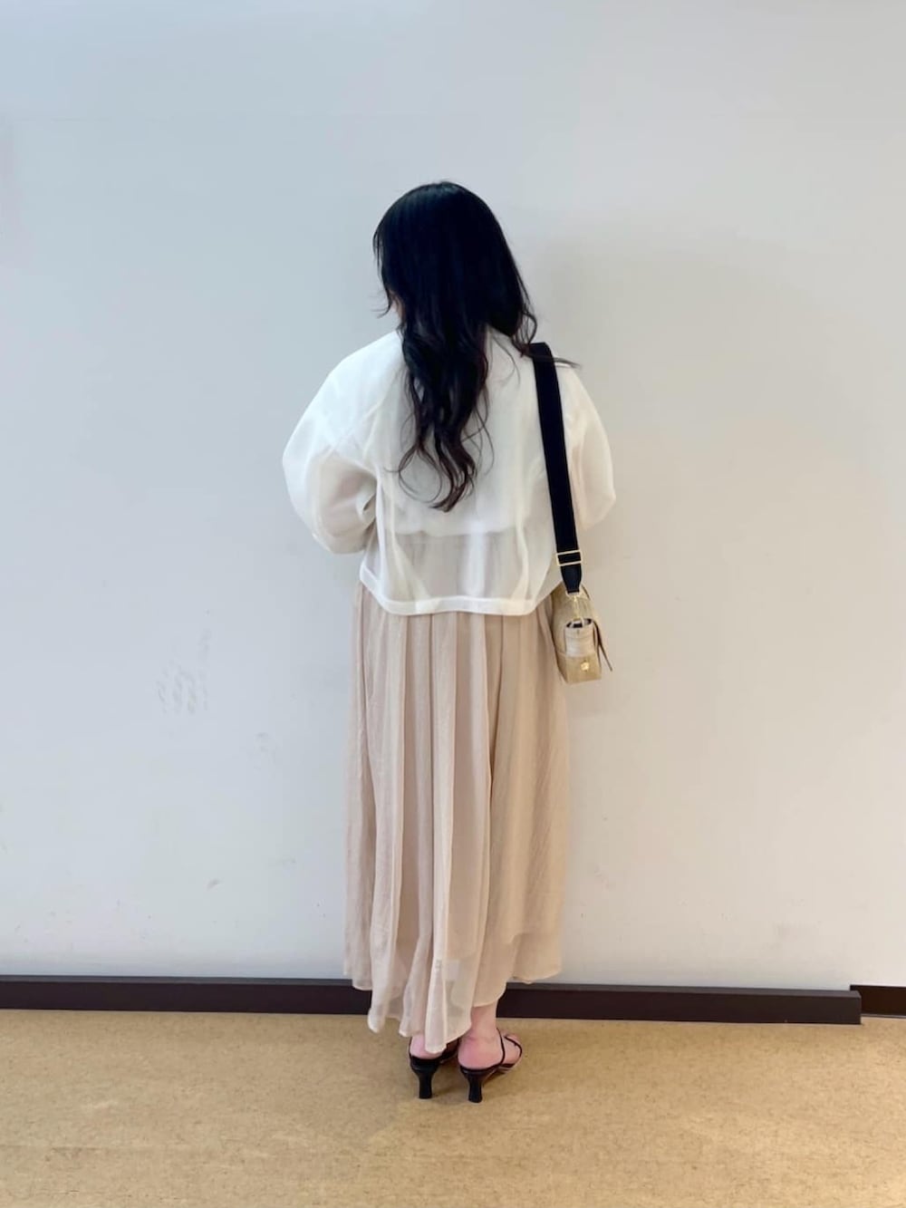 ホワイト系のTシャツ/カットソー、ホワイト系のブルゾン、ベージュ系のスカートを着用したレディースの夏コーディネートの3枚目の写真