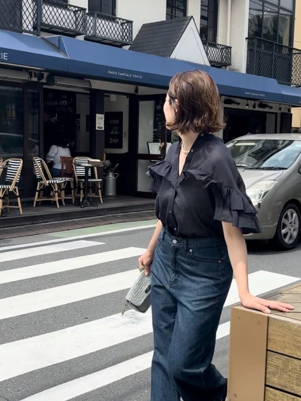 ブラック系のシャツ/ブラウス、ブルー系のデニムパンツを着用したレディースの夏コーディネートの5枚目の写真