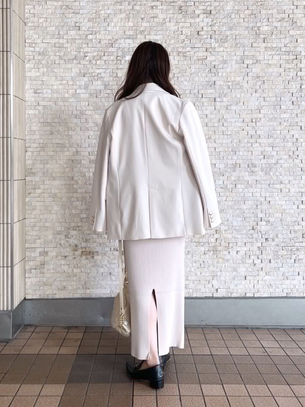 ベージュ系のスカート、ブラック系のローファーを着用したレディースの秋コーディネートの3枚目の写真