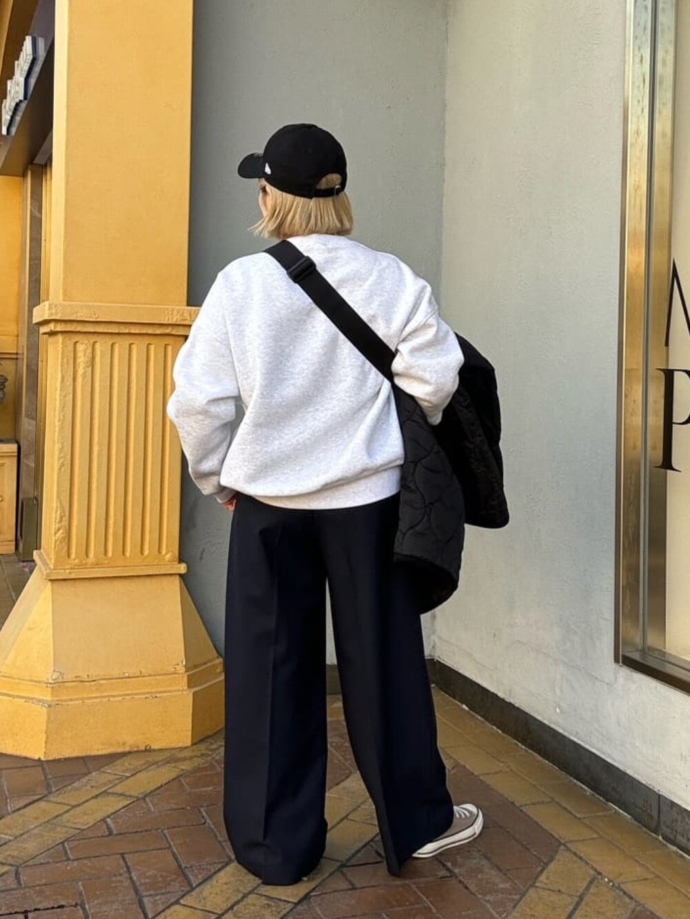 グレー系のスウェット、ブラック系のダウンジャケット/コート、ブルー系のその他パンツを着用したレディースの冬コーディネートの4枚目の写真