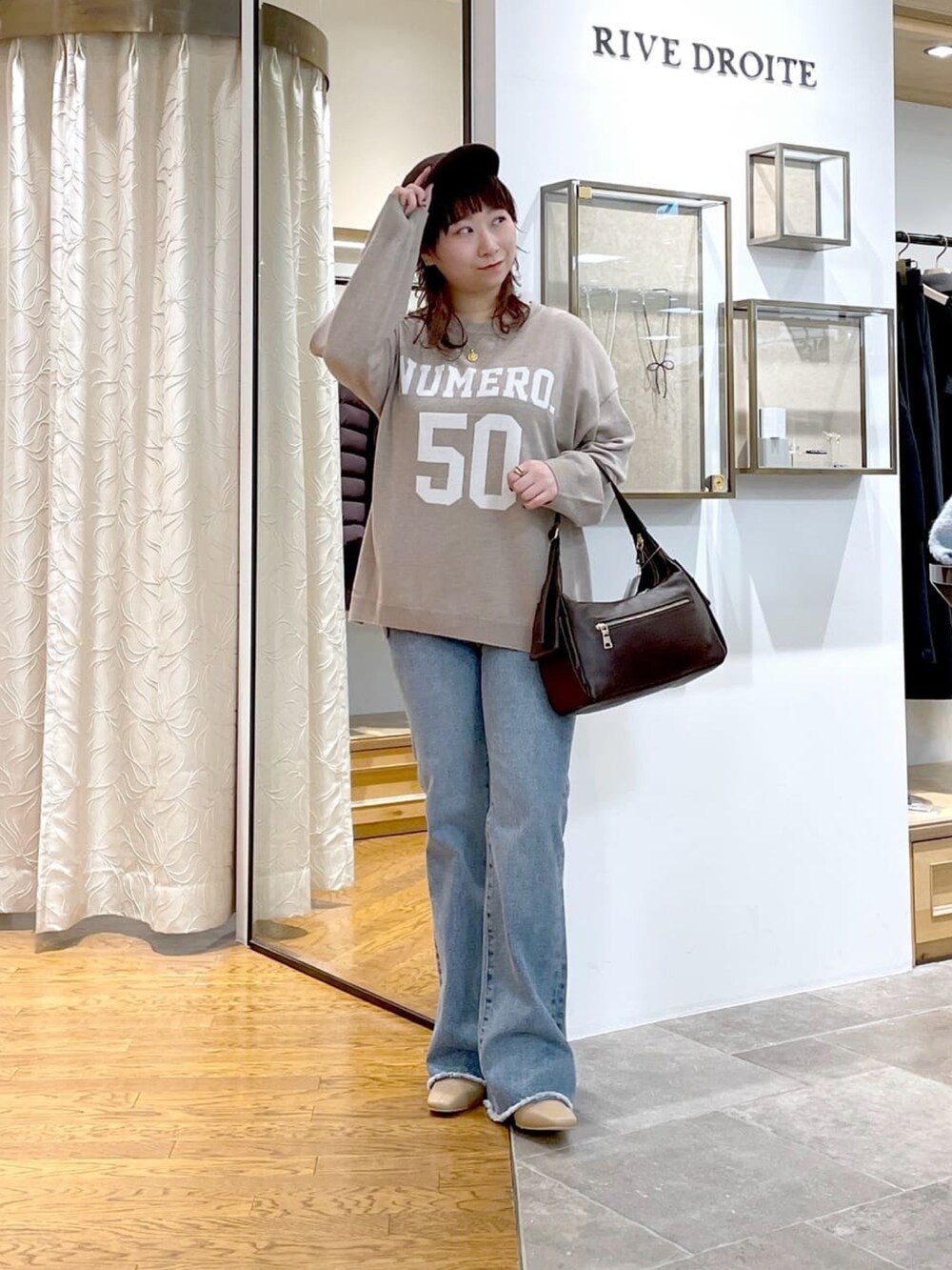 ブラウン系のショルダーバッグ、ベージュ系のニット/セーター、イエロー系のその他アウターを着用したレディースの秋コーディネートの4枚目の写真