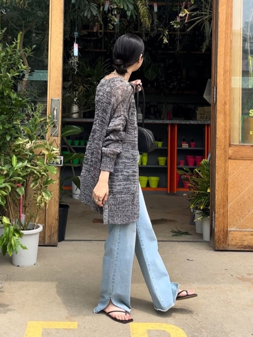 ブラック系のキャミソール、グレー系のカーディガン/ボレロ、ブルー系のデニムパンツを着用したレディースの夏コーディネートの3枚目の写真