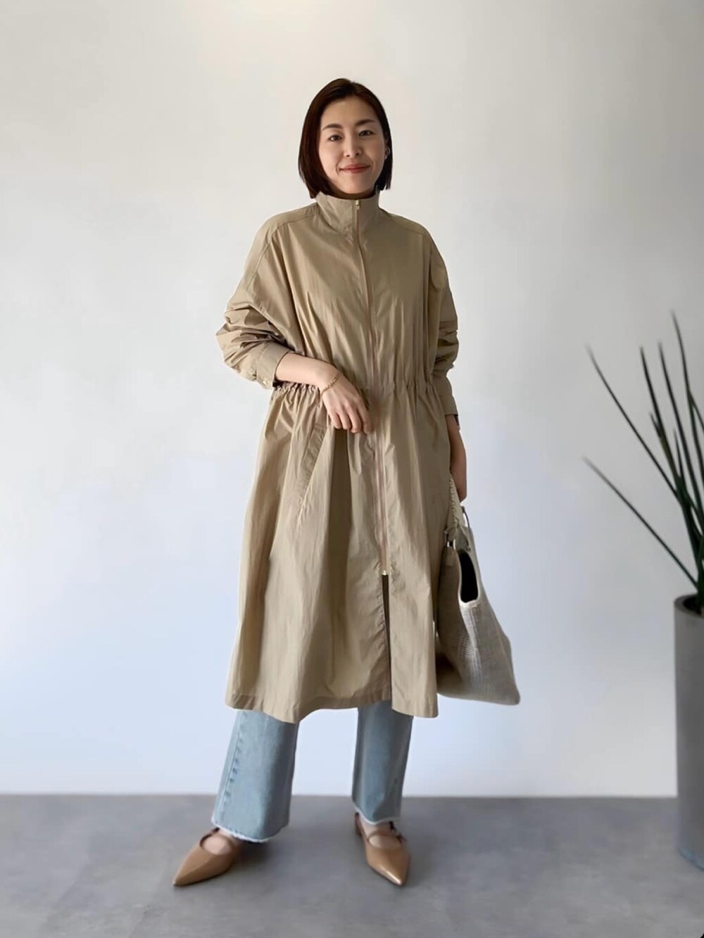 ホワイト系のニット/セーター、ベージュ系のジャケット/アウター、ホワイト系のショルダーバッグを着用したレディースの春コーディネートの4枚目の写真