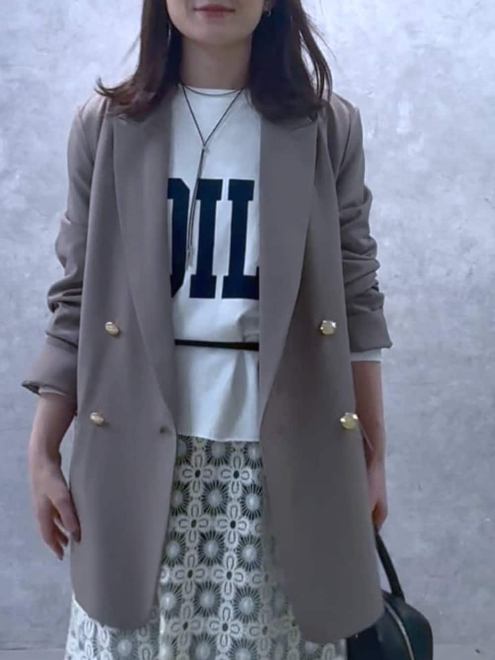 ホワイト系のスウェット、ブラウン系のテーラードジャケット、ブラック系のボストンバッグを着用したレディースの冬コーディネートの6枚目の写真