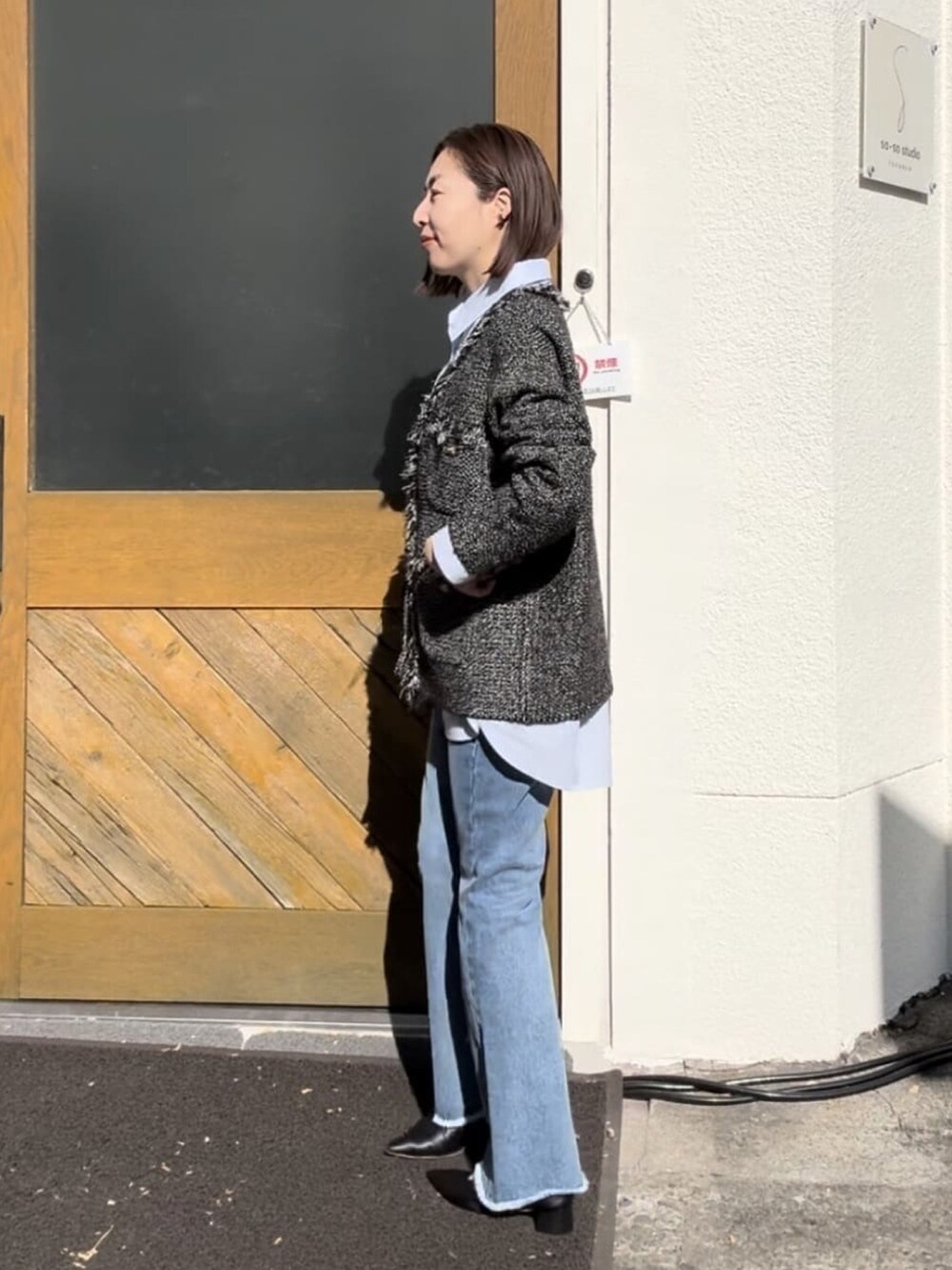 ブラウン系のカーディガン/ボレロ、ブルー系のデニムパンツ、グリーン系のショルダーバッグを着用したレディースの冬コーディネートの4枚目の写真