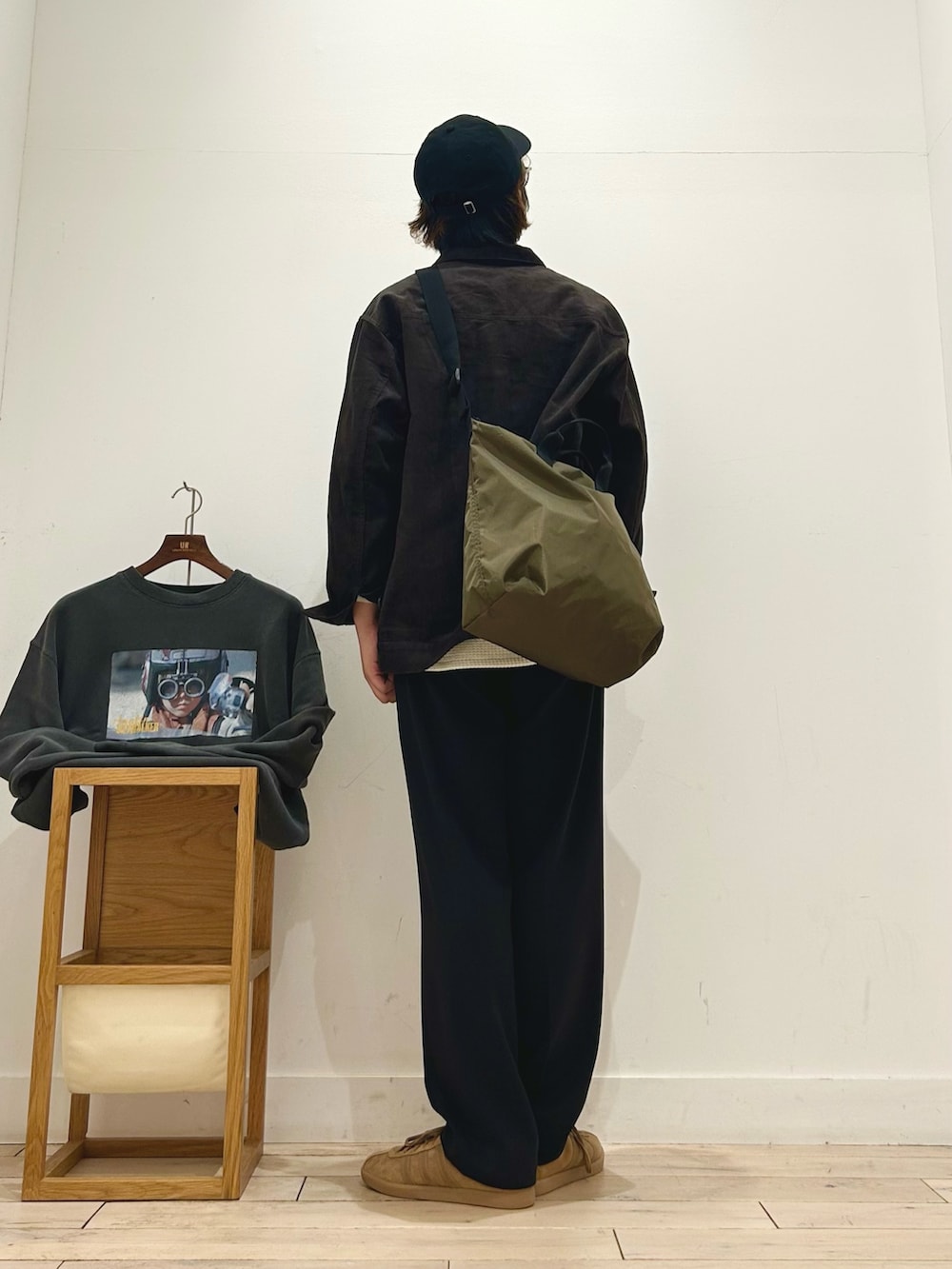 ブラウン系のその他アウター、ホワイト系のTシャツ/カットソー、ベージュ系のショルダーバッグを着用したメンズの秋コーディネートの4枚目の写真