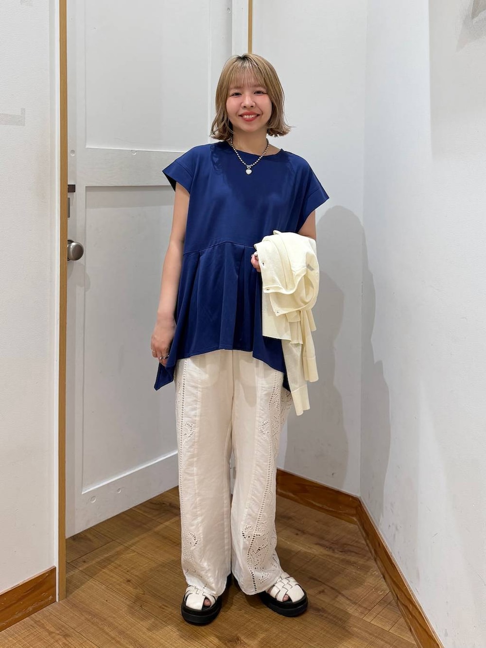 ホワイト系のその他パンツ、ブルー系のTシャツ/カットソー、ベージュ系のカーディガン/ボレロを着用したレディースの春コーディネートの6枚目の写真