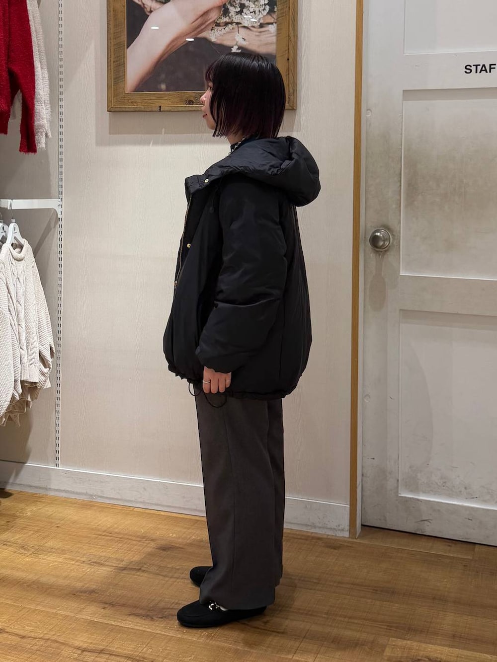 ブラック系のダウンジャケット/コート、ブルー系のニット/セーター、グレー系のその他パンツを着用したレディースの冬コーディネートの5枚目の写真