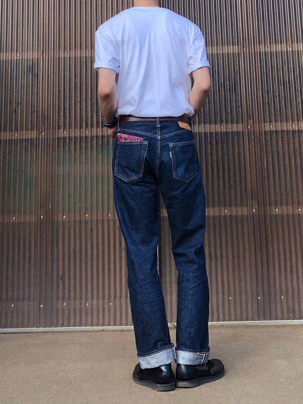ブラック系のブーツ、ブルー系のデニムパンツ、ホワイト系のTシャツ/カットソーを着用したメンズの秋コーディネートの2枚目の写真
