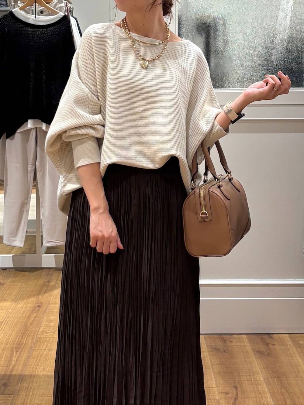 ブラウン系のローファー、グレー系のニット/セーター、ベージュ系のボストンバッグを着用したレディースの秋コーディネートの4枚目の写真