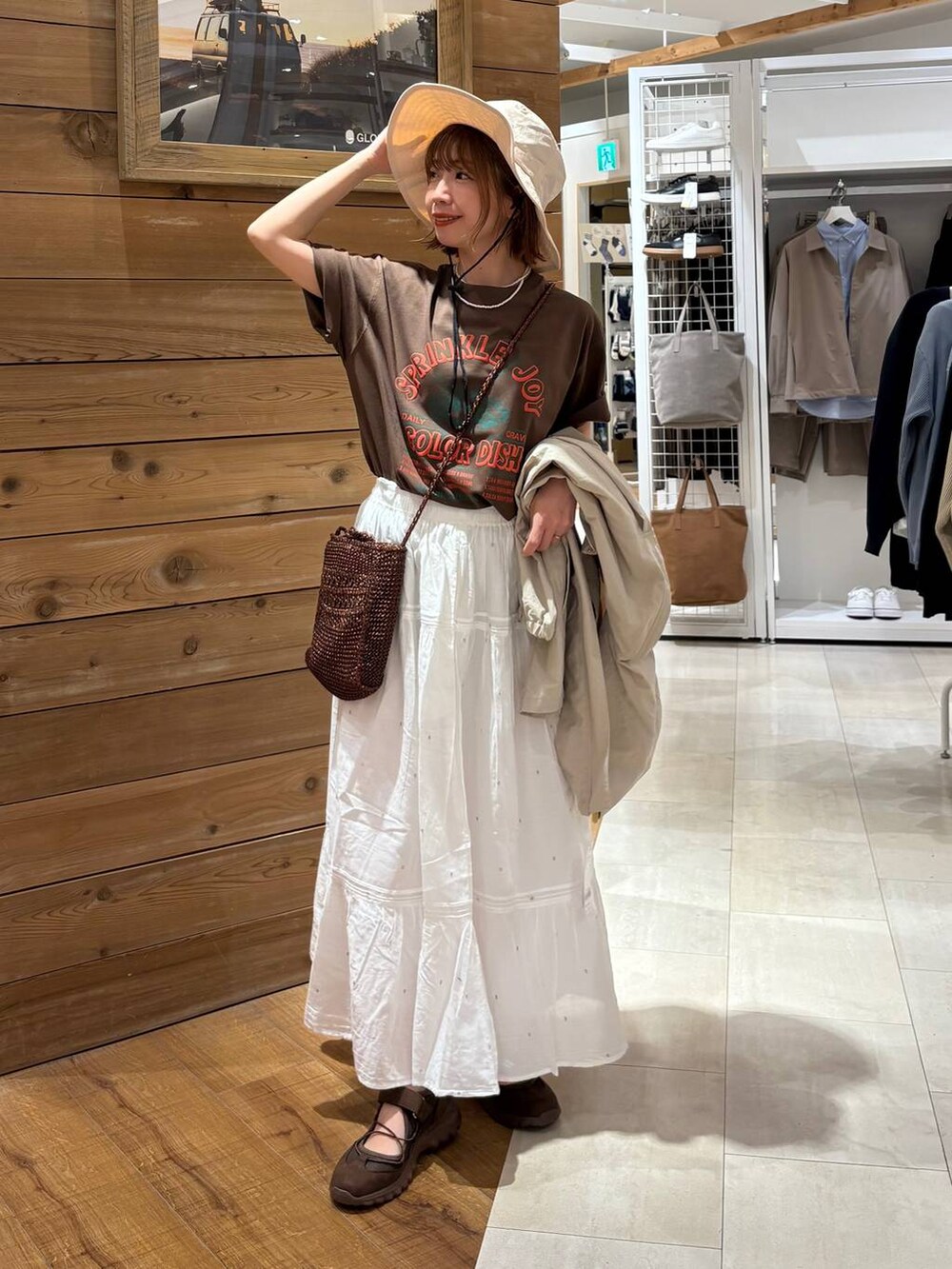 ベージュ系のパーカー、ホワイト系のスカート、ブラウン系のTシャツ/カットソーを着用したレディースの春コーディネートの8枚目の写真