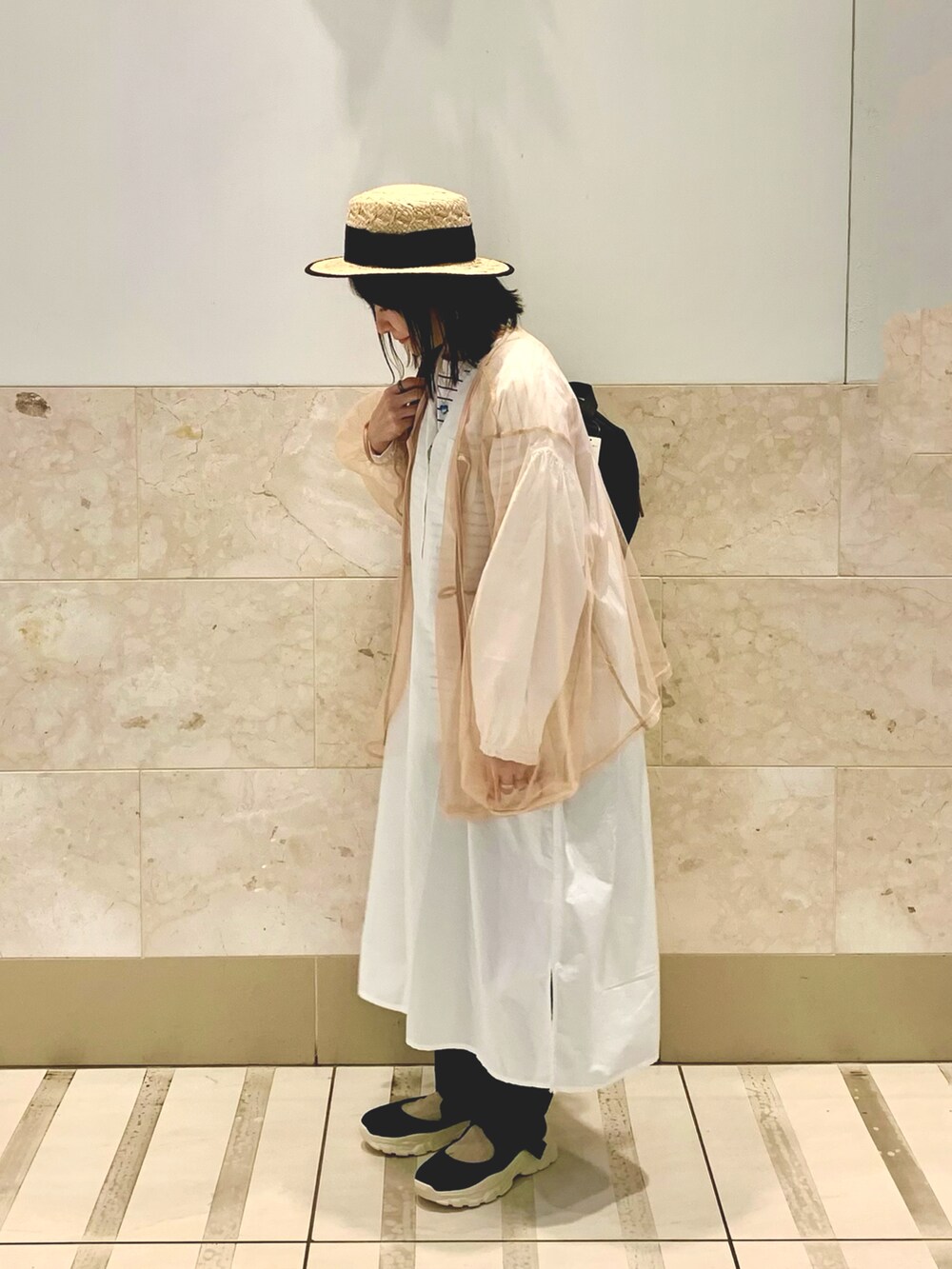 ブラック系のTシャツ/カットソー、ブラック系のスニーカー、ブラック系のスラックスを着用したレディースの春コーディネートの2枚目の写真