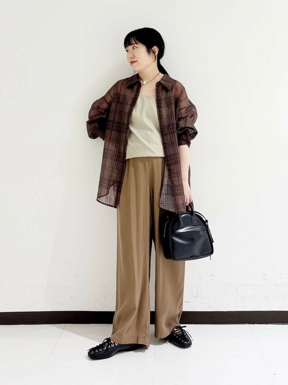 ブラック系のショルダーバッグ、ベージュ系のキャミソール、ブラック系のバレエシューズを着用したレディースの夏コーディネートの5枚目の写真