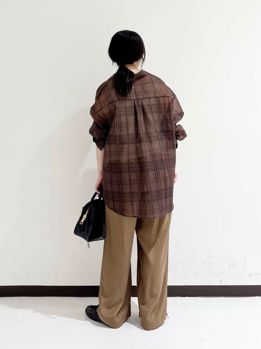 ブラック系のショルダーバッグ、ベージュ系のキャミソール、ブラック系のバレエシューズを着用したレディースの夏コーディネートの3枚目の写真