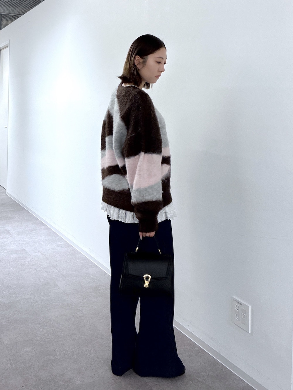 ブラウン系のTシャツ/カットソー、ブルー系のデニムパンツ、ホワイト系のトートバッグを着用したレディースの秋コーディネートの3枚目の写真