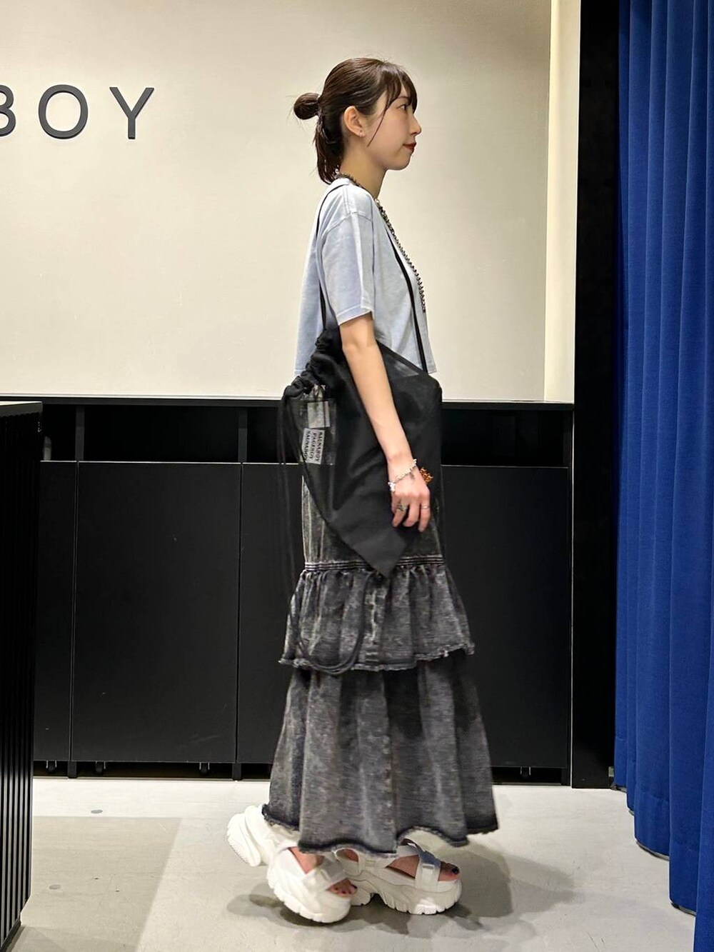 ホワイト系のサンダル、ブラック系のデニムスカート、ブルー系のTシャツ/カットソーを着用したレディースの春コーディネートの5枚目の写真