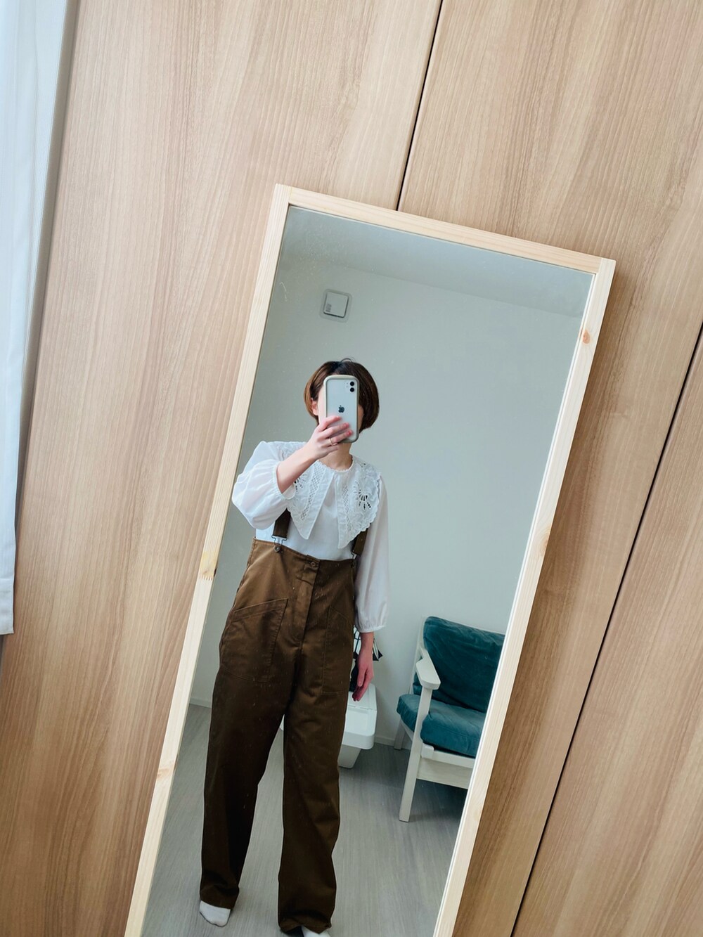 ブラウン系のオールインワン・サロペット、ブラック系のバッグを着用したレディースの春コーディネートの2枚目の写真