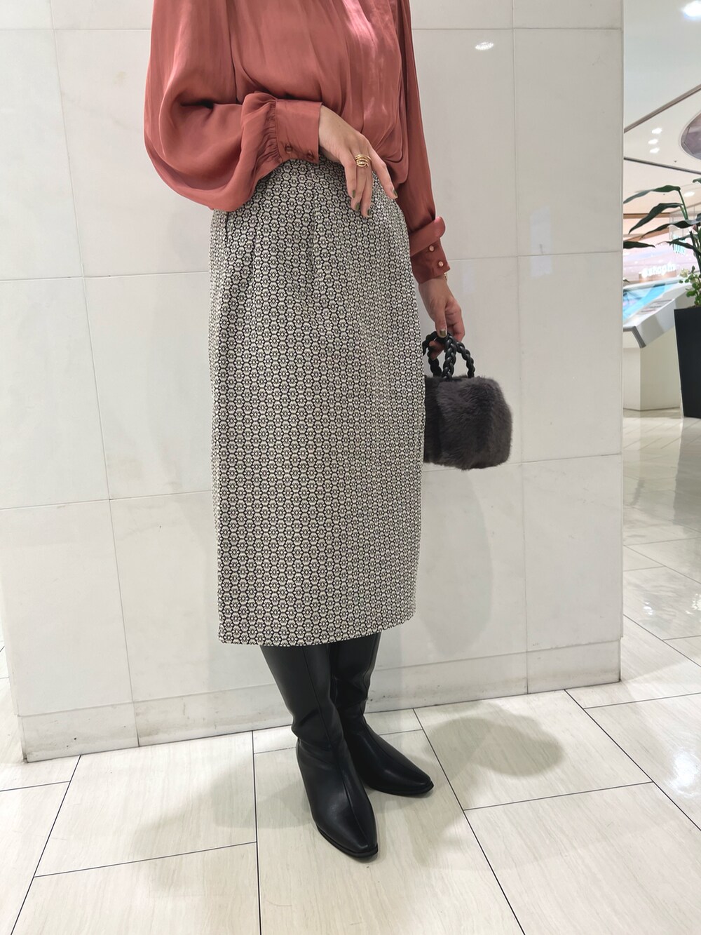 ピンク系のシャツ/ブラウス、ホワイト系のスカート、グレー系のハンドバッグを着用したレディースの秋コーディネートの3枚目の写真