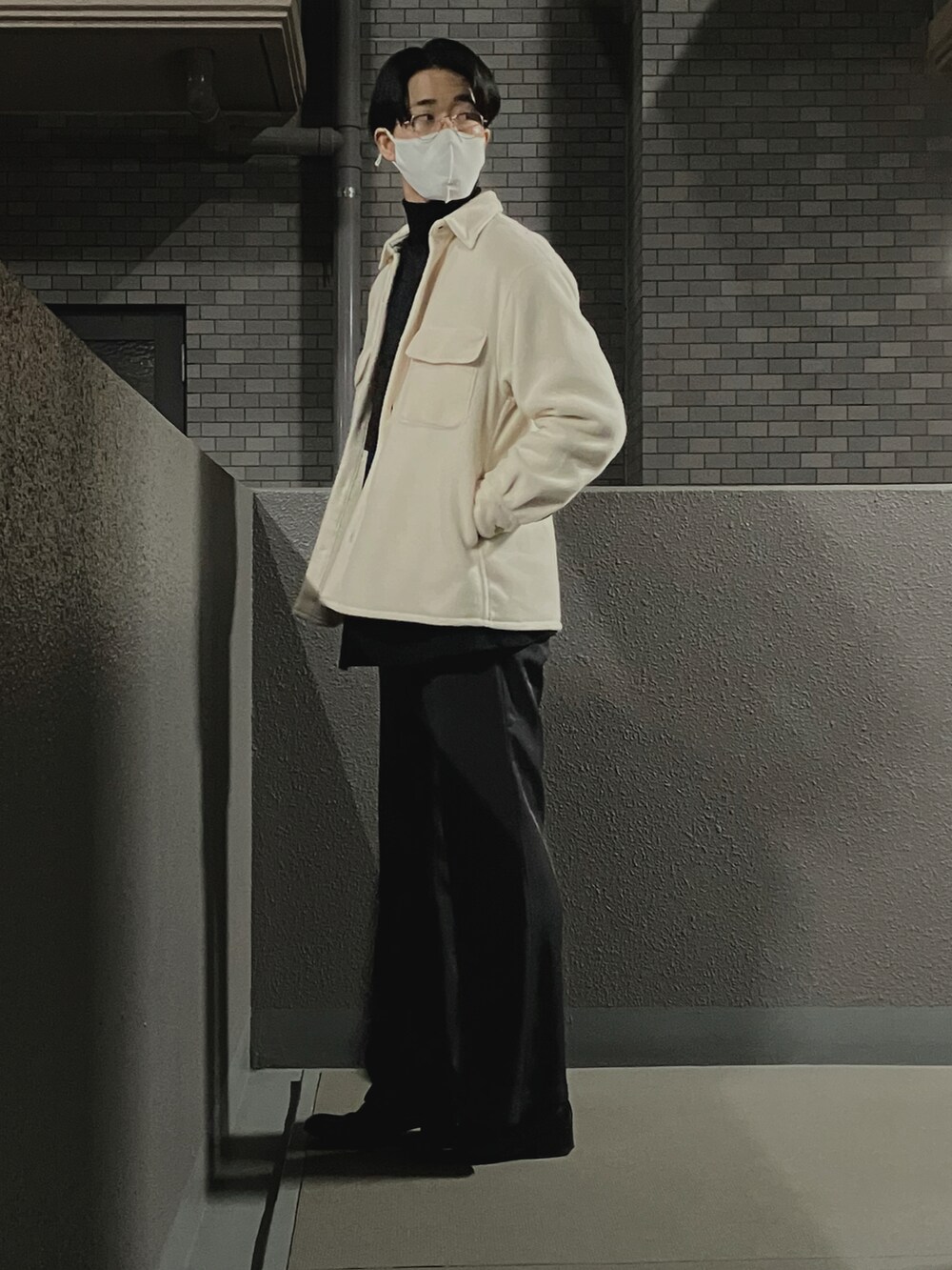 ブラック系のドレスシューズ、グレー系のスラックス、ブラック系のニット/セーターを着用したメンズの秋コーディネートの2枚目の写真