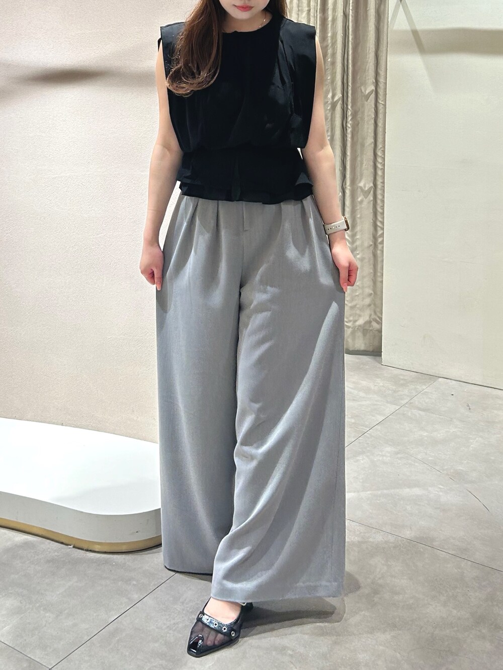 グレー系のその他パンツ、ブラック系のTシャツ/カットソー、ブラック系のパンプスを着用したレディースの春コーディネートの2枚目の写真