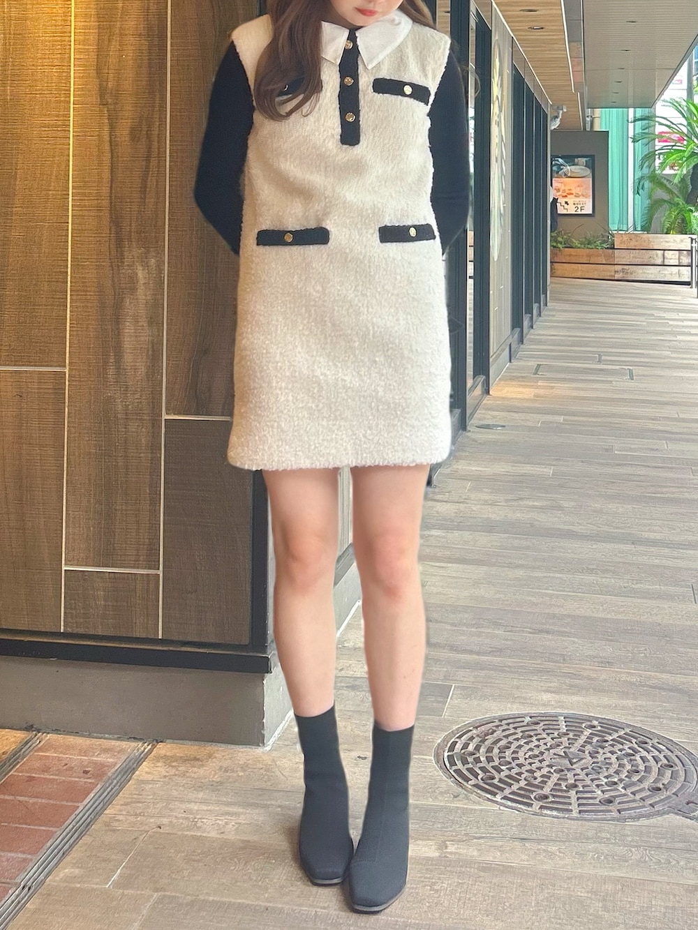 ホワイト系のワンピース、ブラック系のニット/セーター、その他のブーツを着用したレディースの秋コーディネートの2枚目の写真