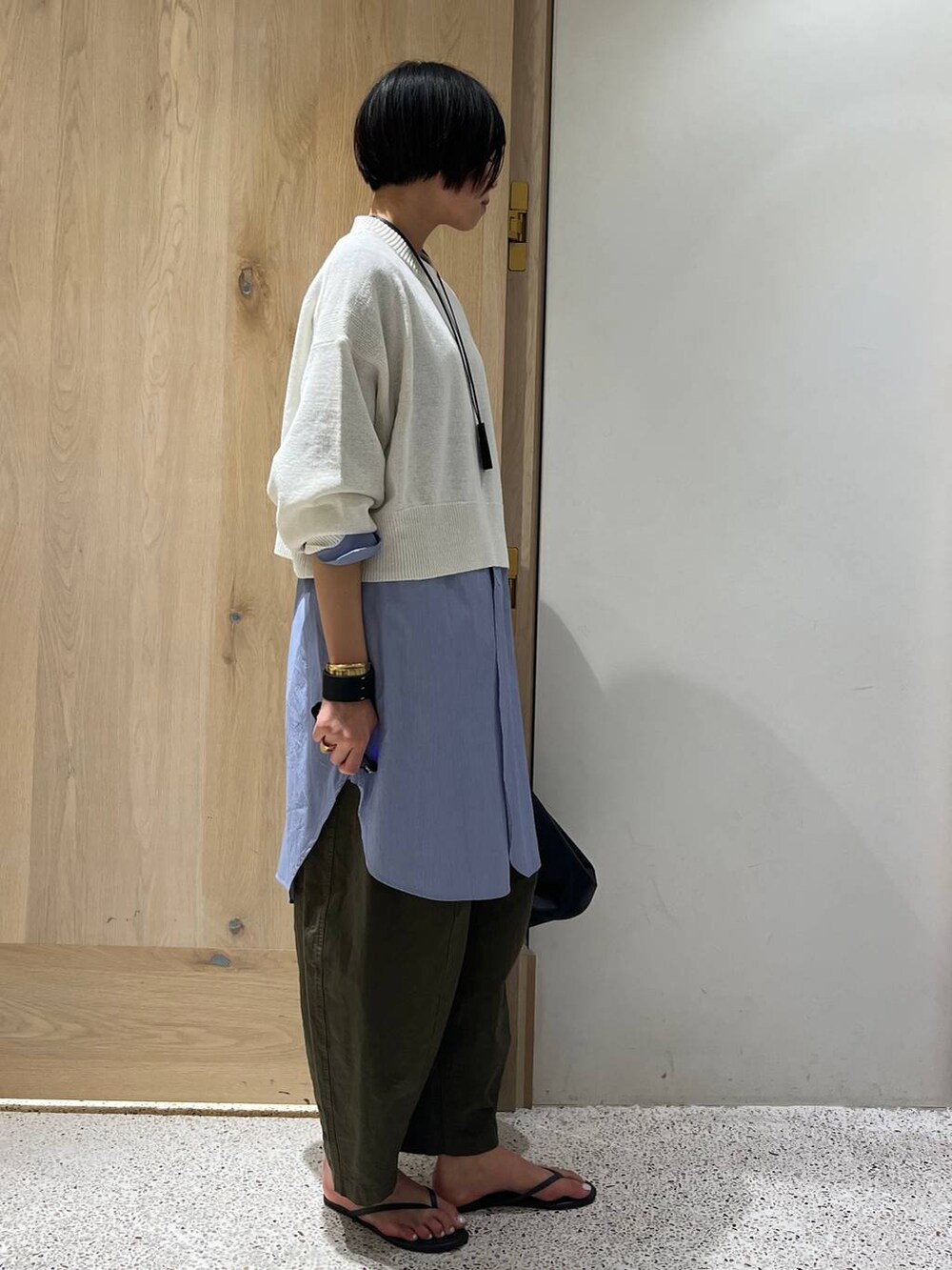 ブルー系のシャツ/ブラウス、グリーン系のその他パンツ、ブラック系のショルダーバッグを着用したレディースの春コーディネートの2枚目の写真