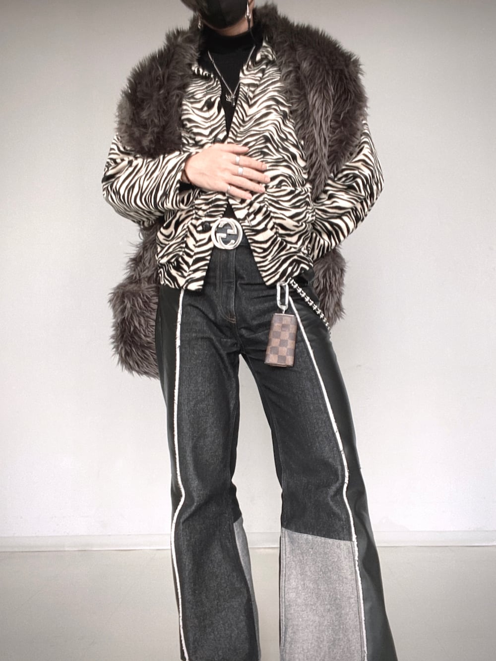 ブラック系のパンツ、ブラック系のシューズ、グレー系のマフラーを着用したメンズの冬コーディネートの4枚目の写真