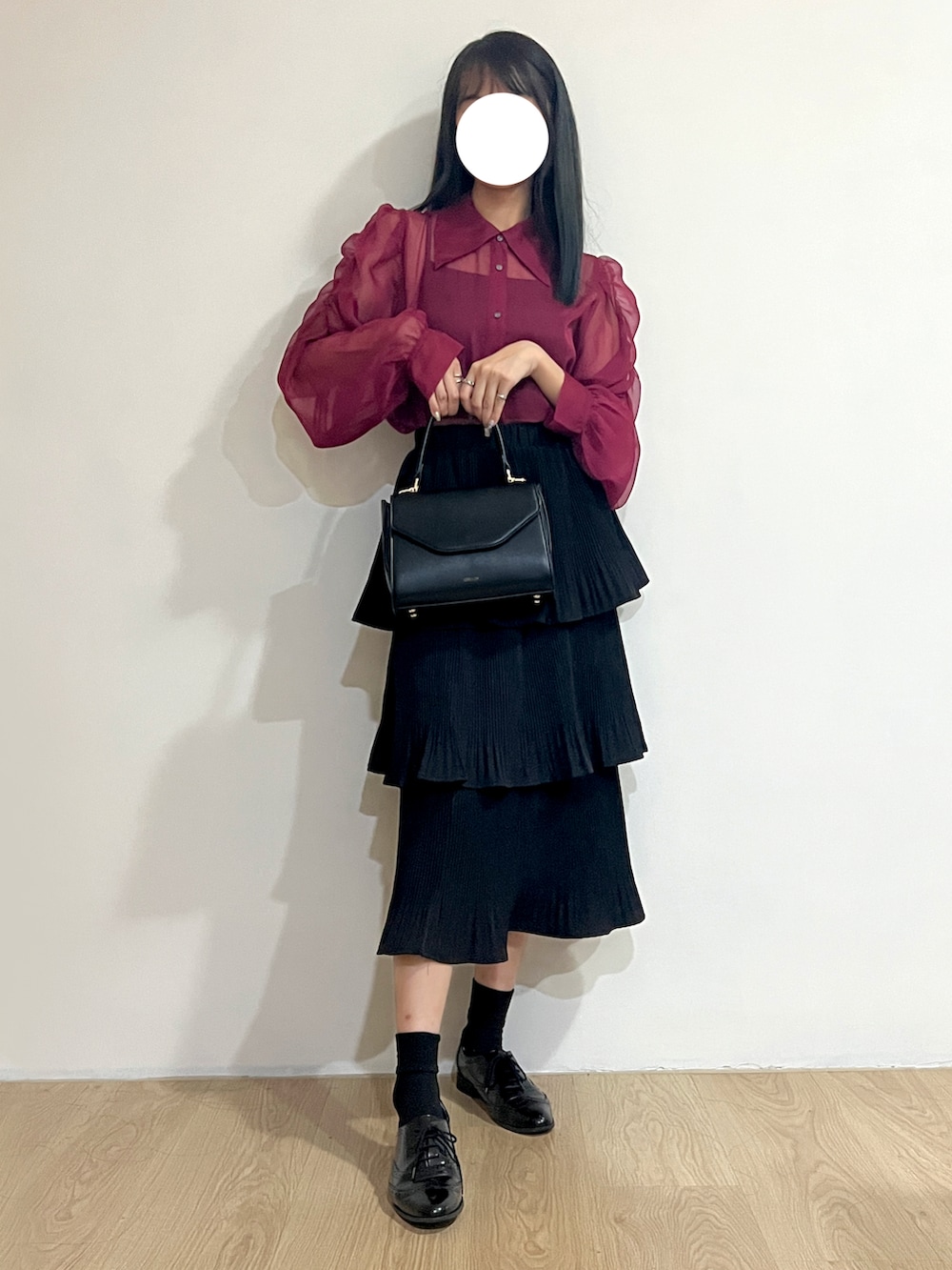 パープル系のシャツ/ブラウス、ブラック系のスカート、ブラック系のショルダーバッグを着用したレディースの冬コーディネートの2枚目の写真