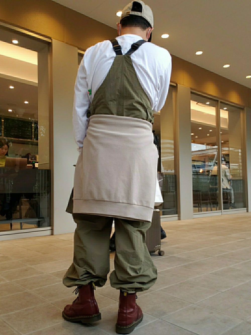 グリーン系のサロペット/オーバーオール、ブラウン系のブーツ、ホワイト系のTシャツ/カットソーを着用したメンズの春コーディネートの3枚目の写真