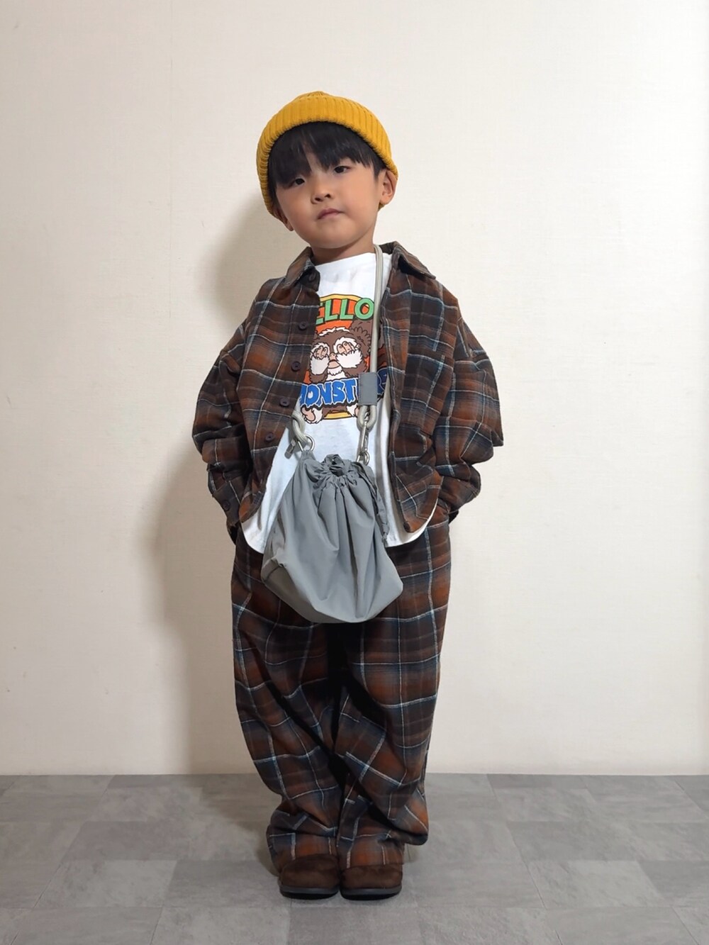 ホワイト系のTシャツ/カットソー、グレー系のショルダーバッグ、オレンジ系のシャツ/ブラウスを着用したキッズの秋コーディネートの2枚目の写真