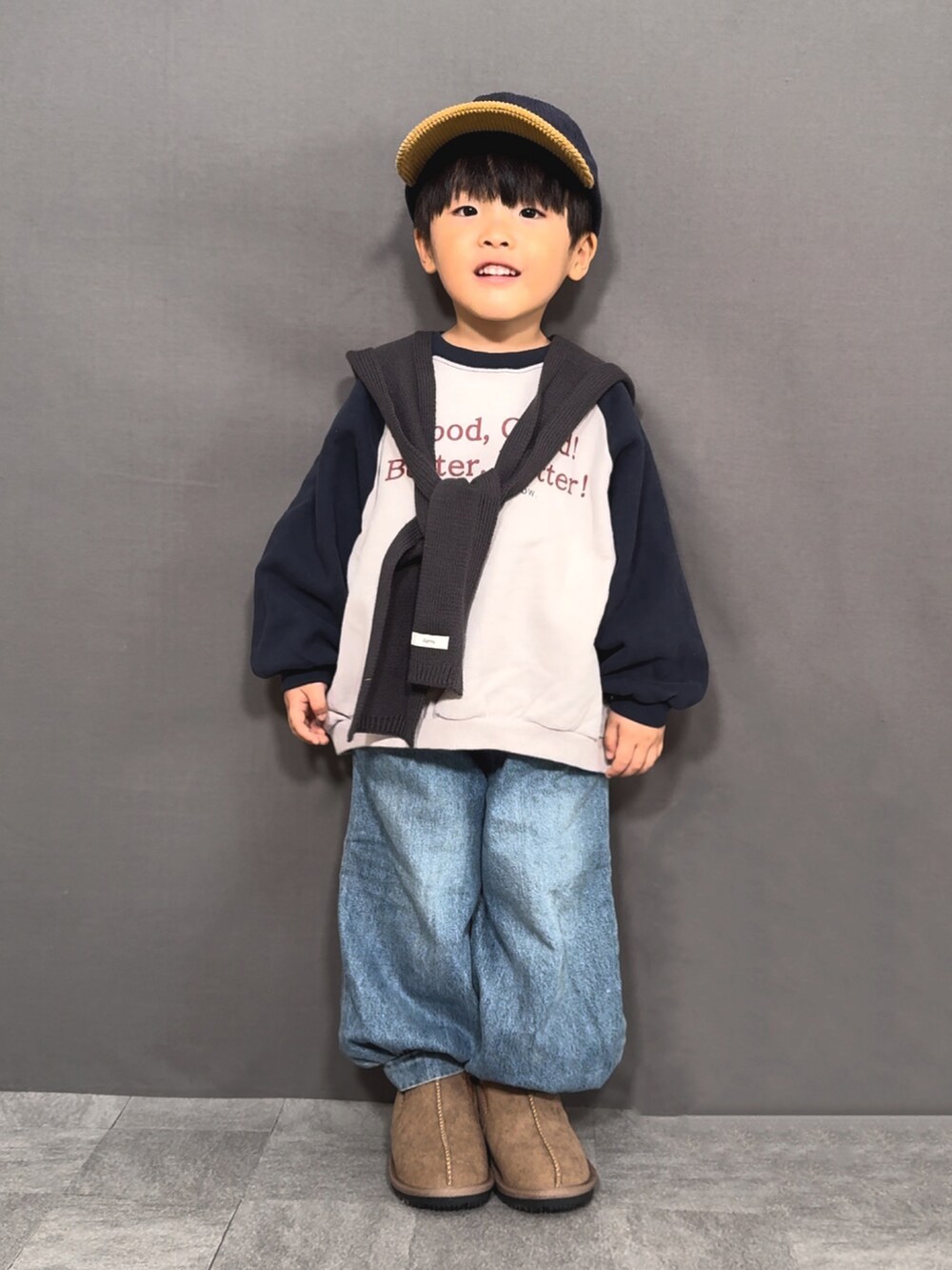グレー系のスウェット、ブルー系のデニムパンツ、イエロー系のブーツを着用したキッズの冬コーディネートの4枚目の写真