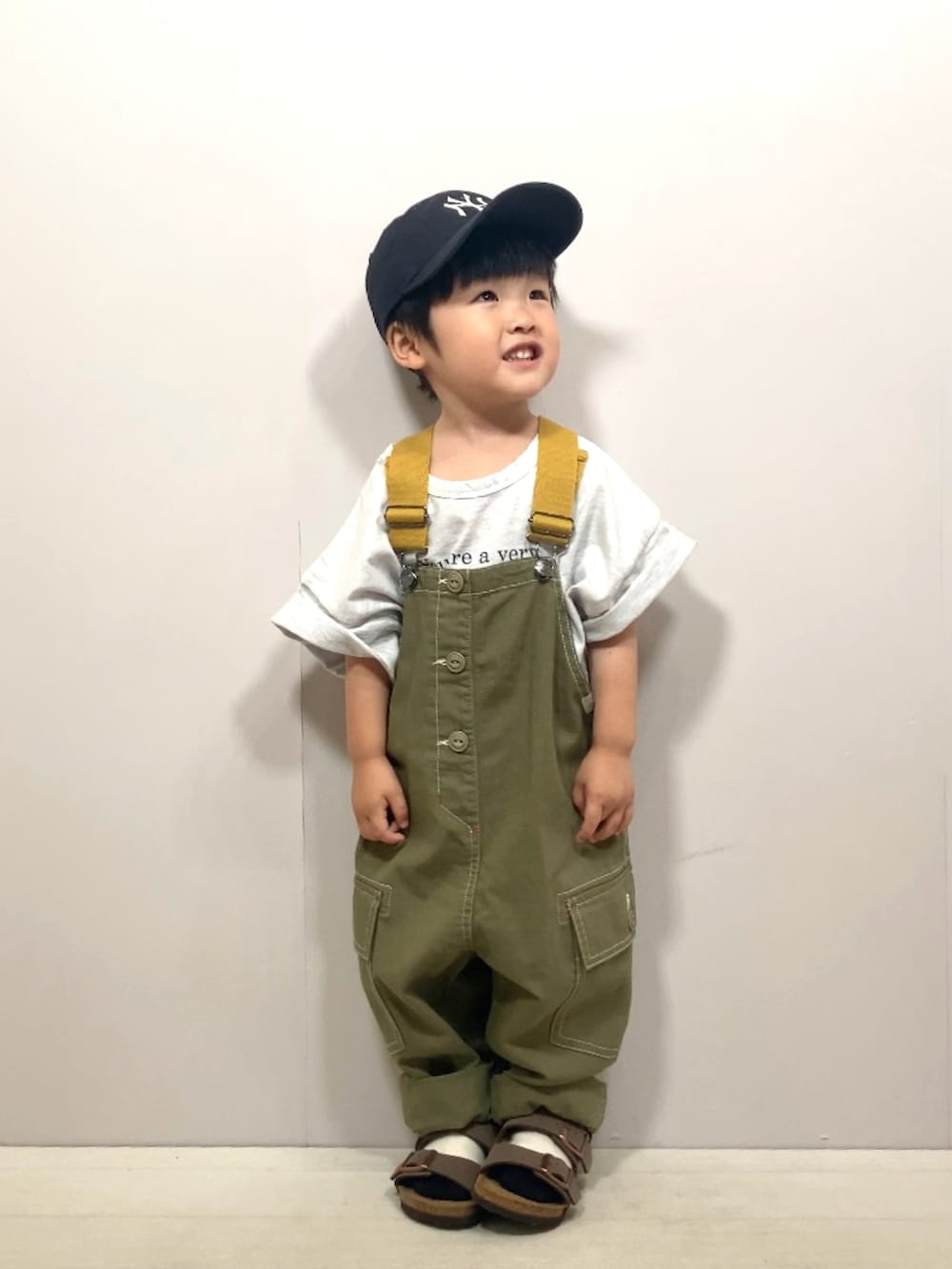 グレー系のTシャツ/カットソー、グリーン系のサロペット/オーバーオール、ブラック系のショルダーバッグを着用したキッズの夏コーディネートの3枚目の写真