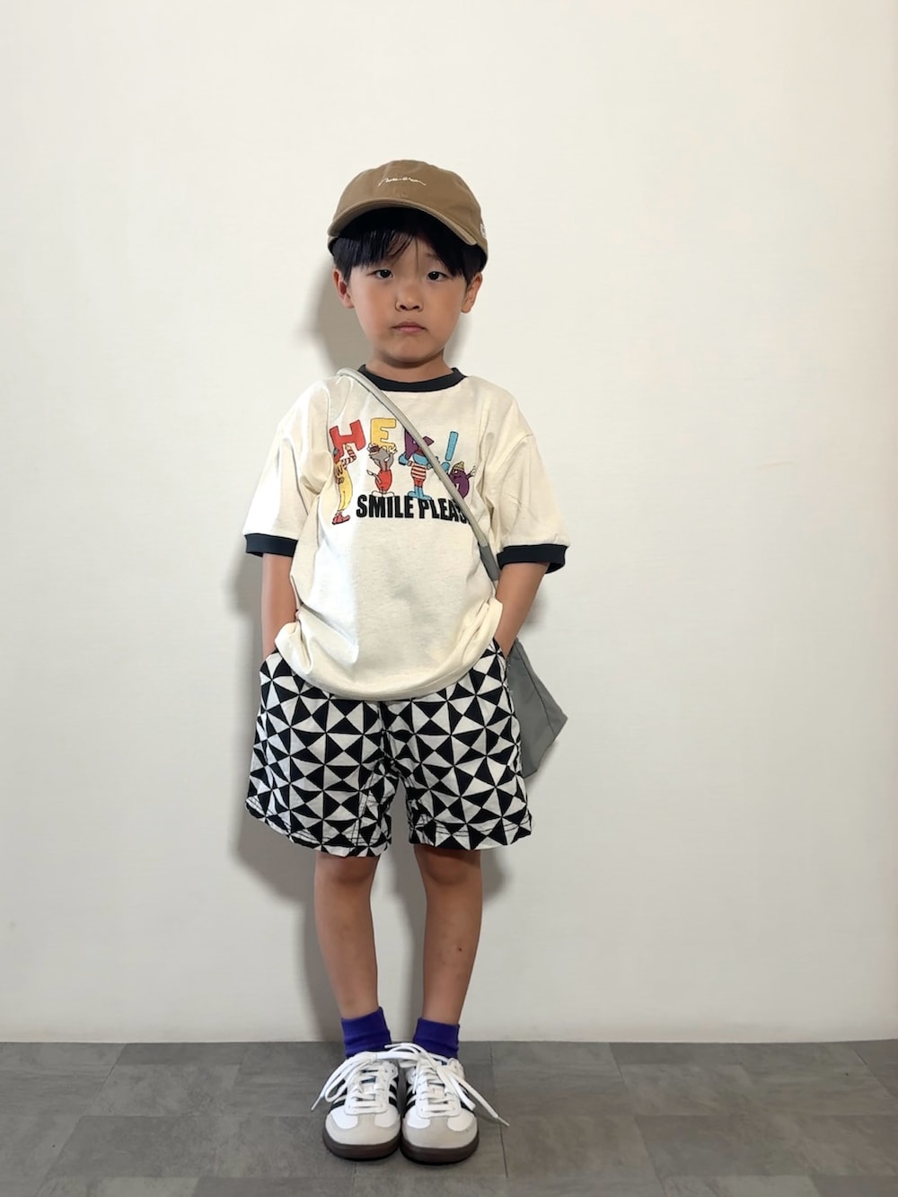 グレー系のショルダーバッグ、ホワイト系のTシャツ/カットソー、ブラック系のその他パンツを着用したキッズの春コーディネートの2枚目の写真