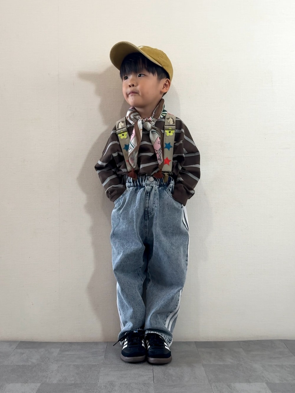 ブルー系のデニムパンツ、ブラック系のスニーカー、ブラウン系のTシャツ/カットソーを着用したキッズの秋コーディネートの3枚目の写真