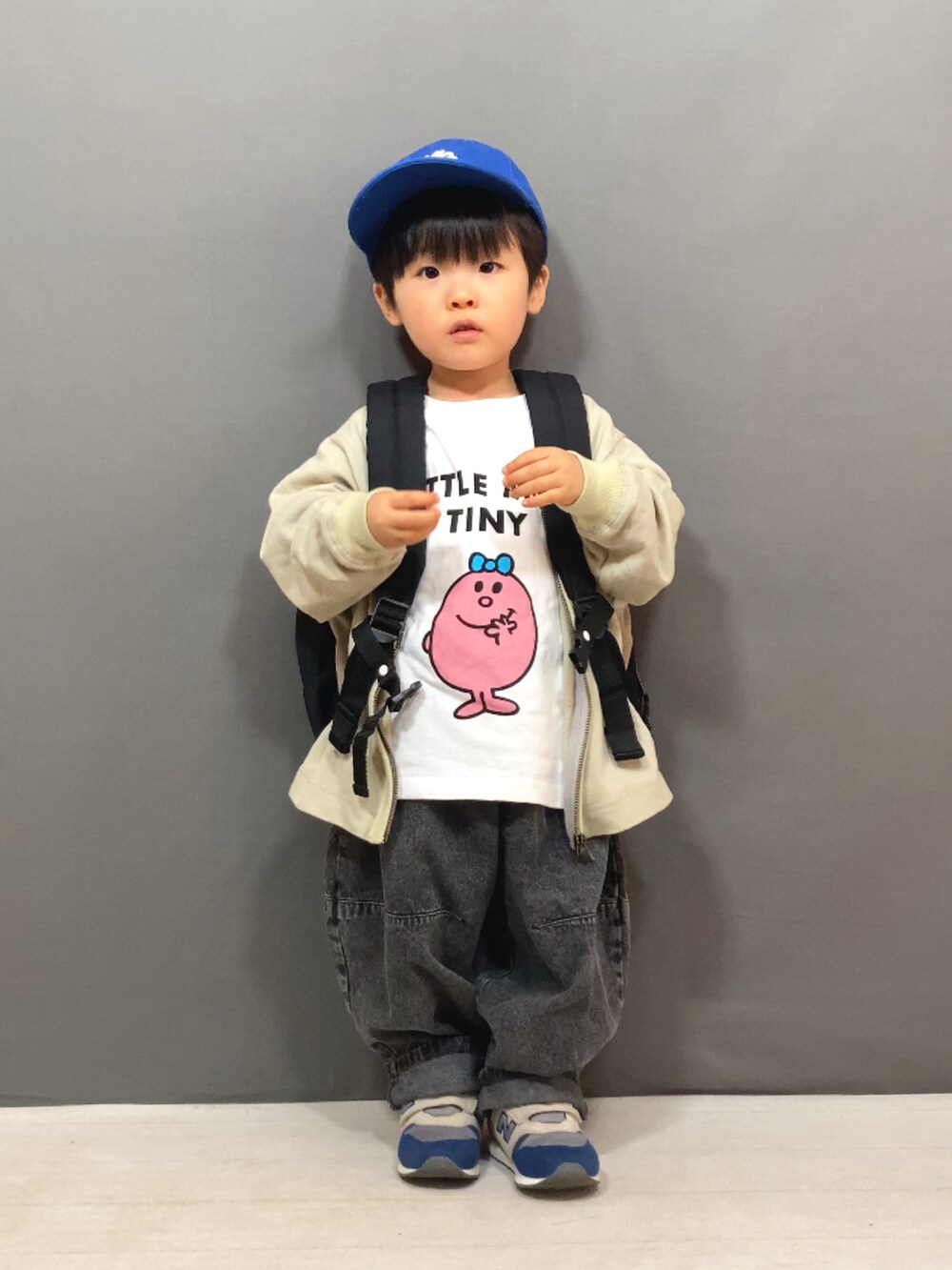 ベージュ系のカーディガン/ボレロ、ピンク系のTシャツ/カットソー、ブラック系のデニムパンツを着用したキッズの冬コーディネートの2枚目の写真