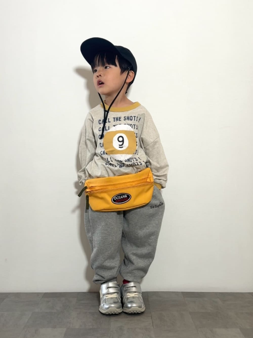 シルバー系のスニーカー、イエロー系のTシャツ/カットソー、グレー系のスウェットパンツを着用したキッズの春コーディネートの2枚目の写真