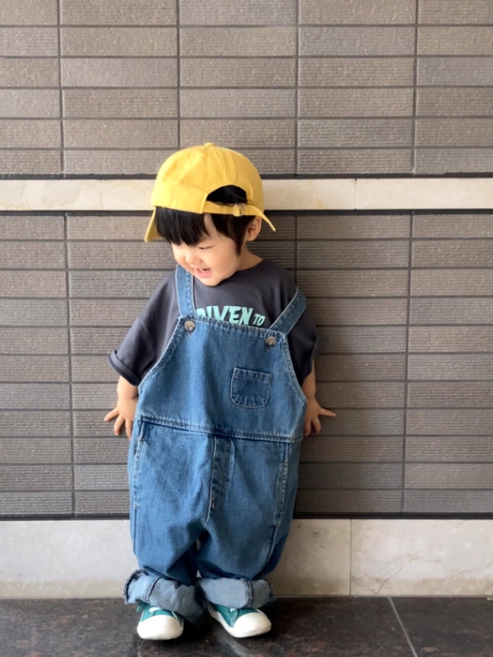 グレー系のTシャツ/カットソー、ブルー系のオールインワン・サロペット、グリーン系のスニーカーを着用したキッズの夏コーディネートの2枚目の写真