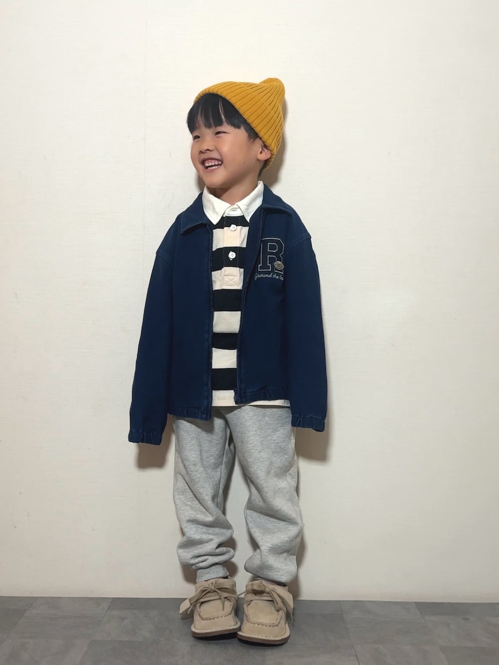 ベージュ系のモカシン/デッキシューズ、ホワイト系のポロシャツ、ブルー系のジャケット/アウターを着用したキッズの冬コーディネートの2枚目の写真