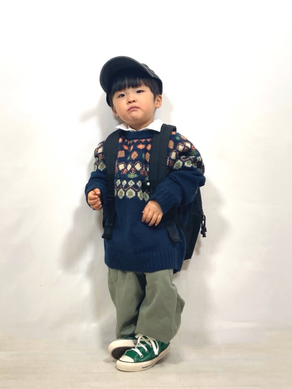 ブルー系のニット/セーター、ホワイト系のシャツ/ブラウス、グリーン系のカーゴパンツを着用したキッズの冬コーディネートの3枚目の写真