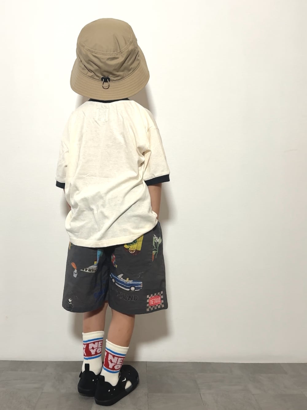 ブラック系のサンダル、ホワイト系のTシャツ/カットソー、グレー系のその他パンツを着用したキッズの夏コーディネートの3枚目の写真