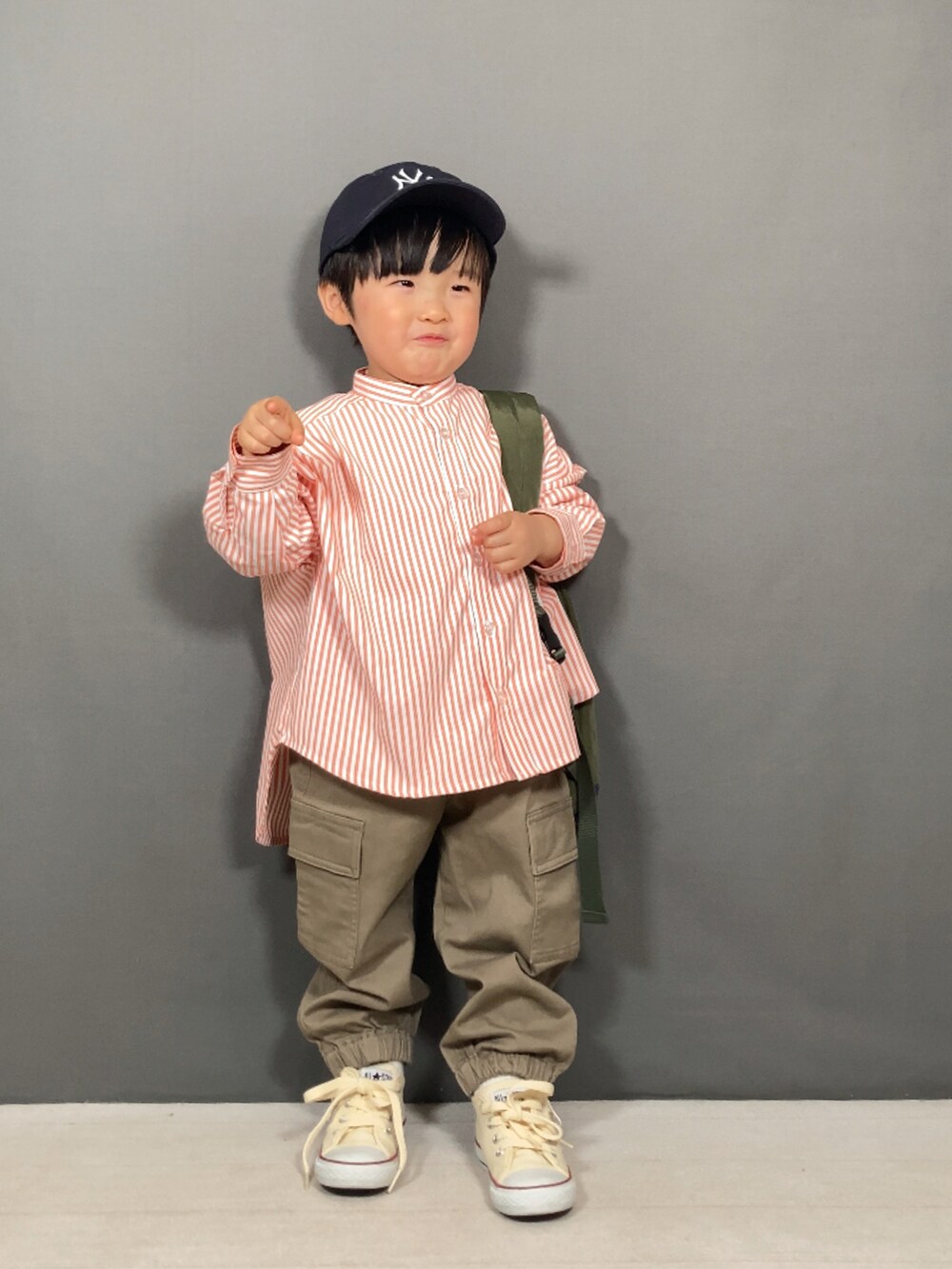 オレンジ系のシャツ/ブラウス、ブラック系のパンツ、グリーン系のボディバッグ/ウエストポーチを着用したキッズの春コーディネートの4枚目の写真