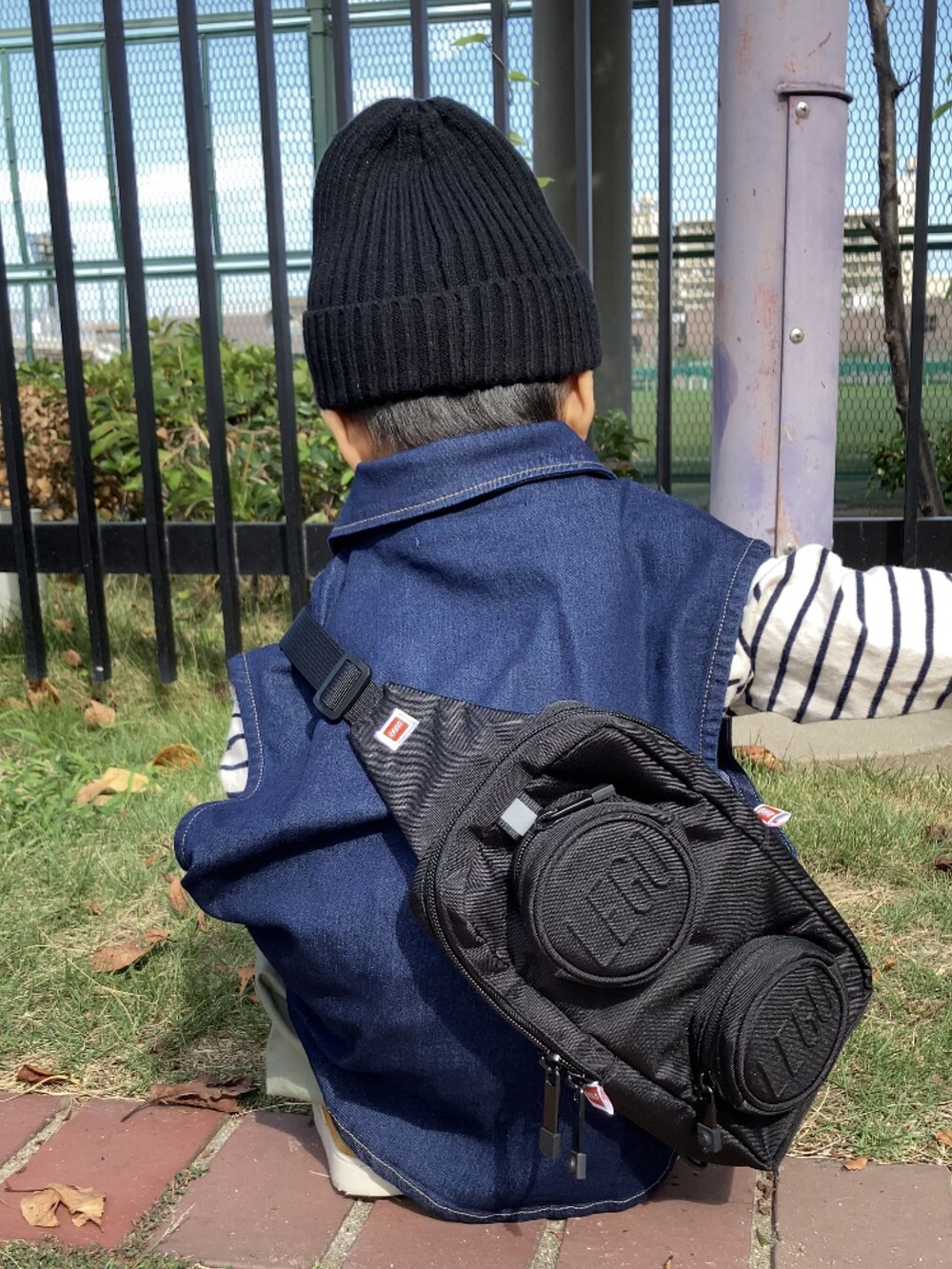 ブルー系のベスト、ホワイト系のTシャツ/カットソー、グリーン系のカーゴパンツを着用したキッズの秋コーディネートの5枚目の写真