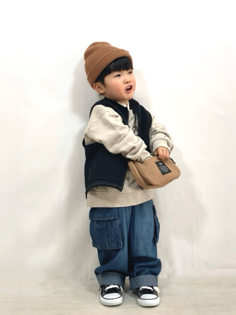 ブラック系のベスト、ホワイト系のスウェット、ホワイト系のTシャツ/カットソーを着用したキッズの冬コーディネートの3枚目の写真