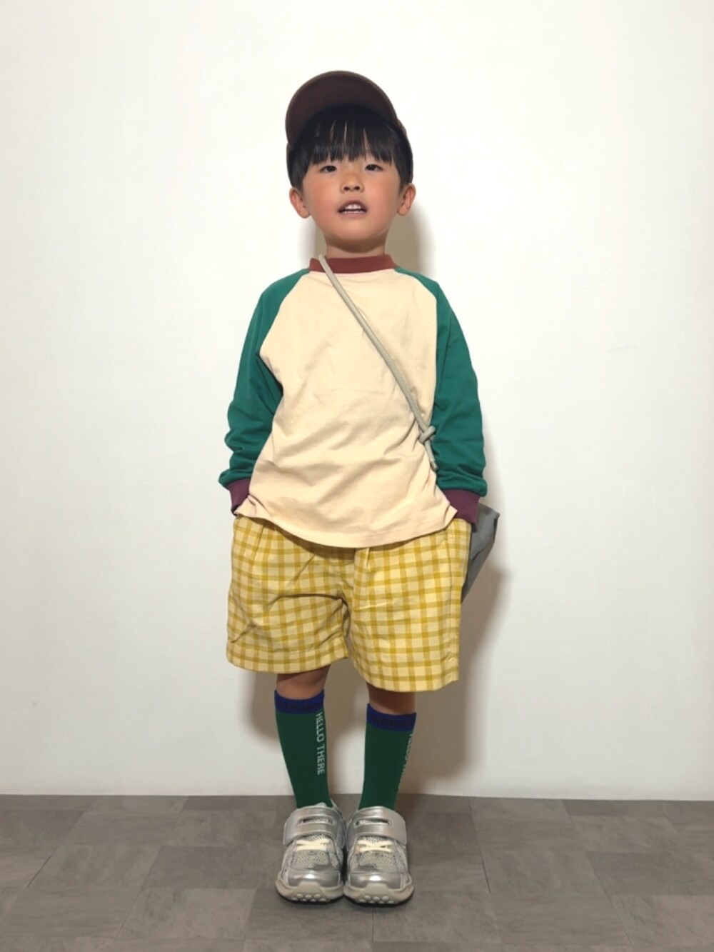 グリーン系のTシャツ/カットソー、イエロー系のその他パンツ、グレー系のショルダーバッグを着用したキッズの春コーディネートの2枚目の写真