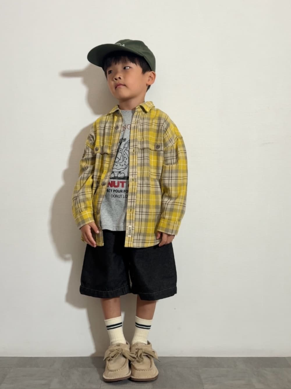 イエロー系のシャツ/ブラウス、グレー系のTシャツ/カットソー、ベージュ系のモカシン/デッキシューズを着用したキッズの秋コーディネートの3枚目の写真