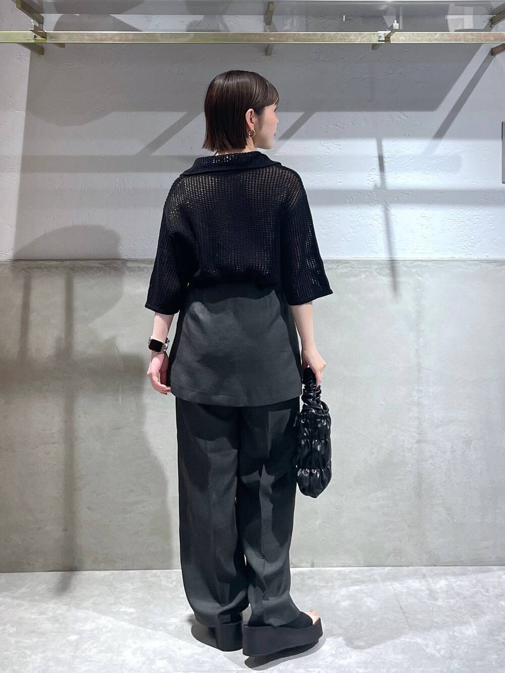 ブラック系のサンダル、ブラック系のショルダーバッグ、ブラック系のニット/セーターを着用したレディースの春コーディネートの4枚目の写真