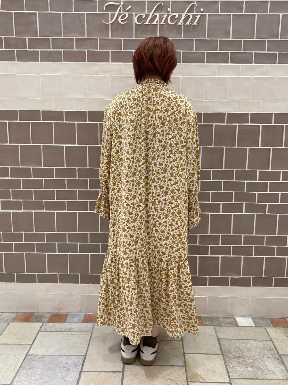 ベージュ系のワンピースを着用したレディースの秋コーディネートの3枚目の写真