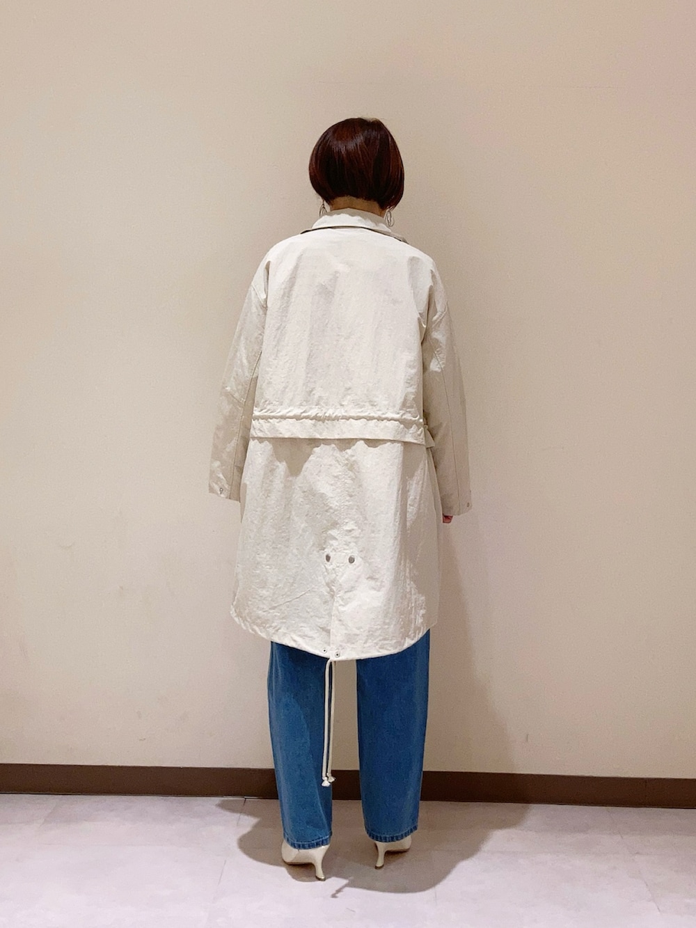 オレンジ系のTシャツ/カットソー、ホワイト系のその他アウター、ブルー系のパンツを着用したレディースの春コーディネートの3枚目の写真