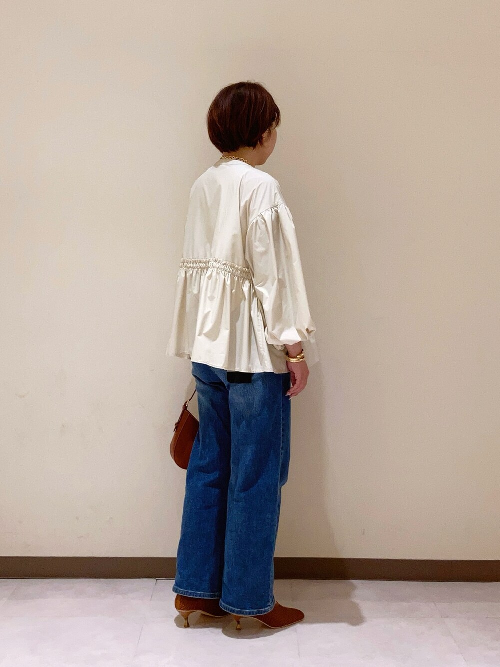 ホワイト系のジャケット/アウターを着用したレディースの春コーディネートの3枚目の写真